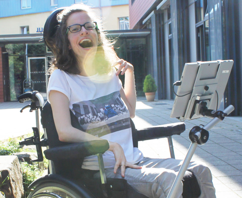Young woman using her Tobii Dynavox PCEye Bracket outside