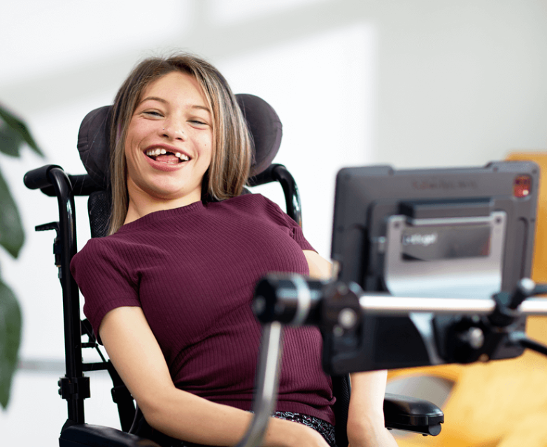 Young woman using Tobii Dynavox TD Pilot device