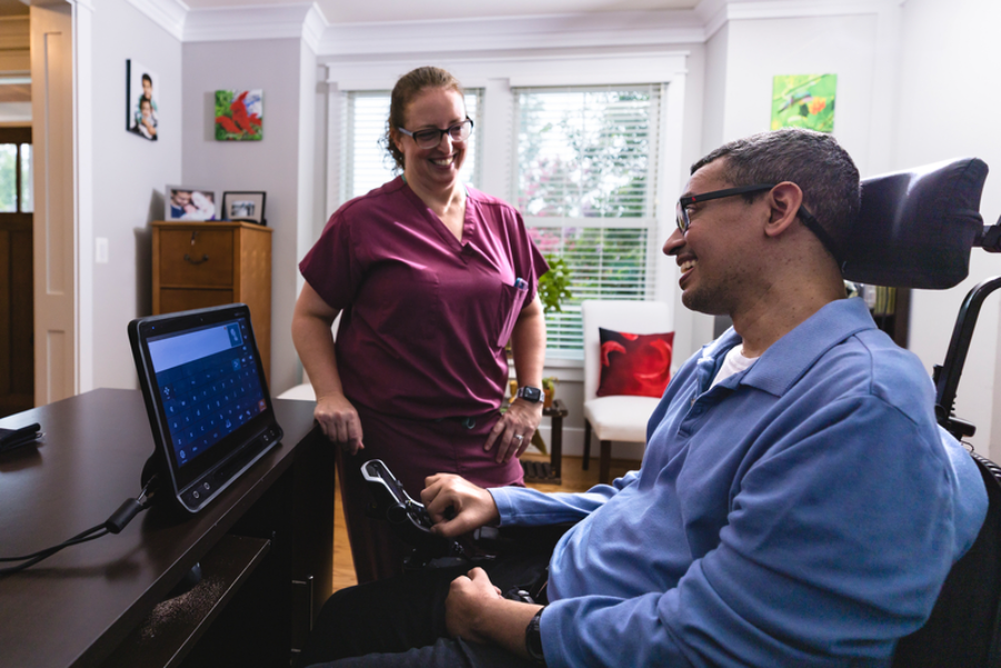 Man with ALS/MND talking to a clinician about his treatment